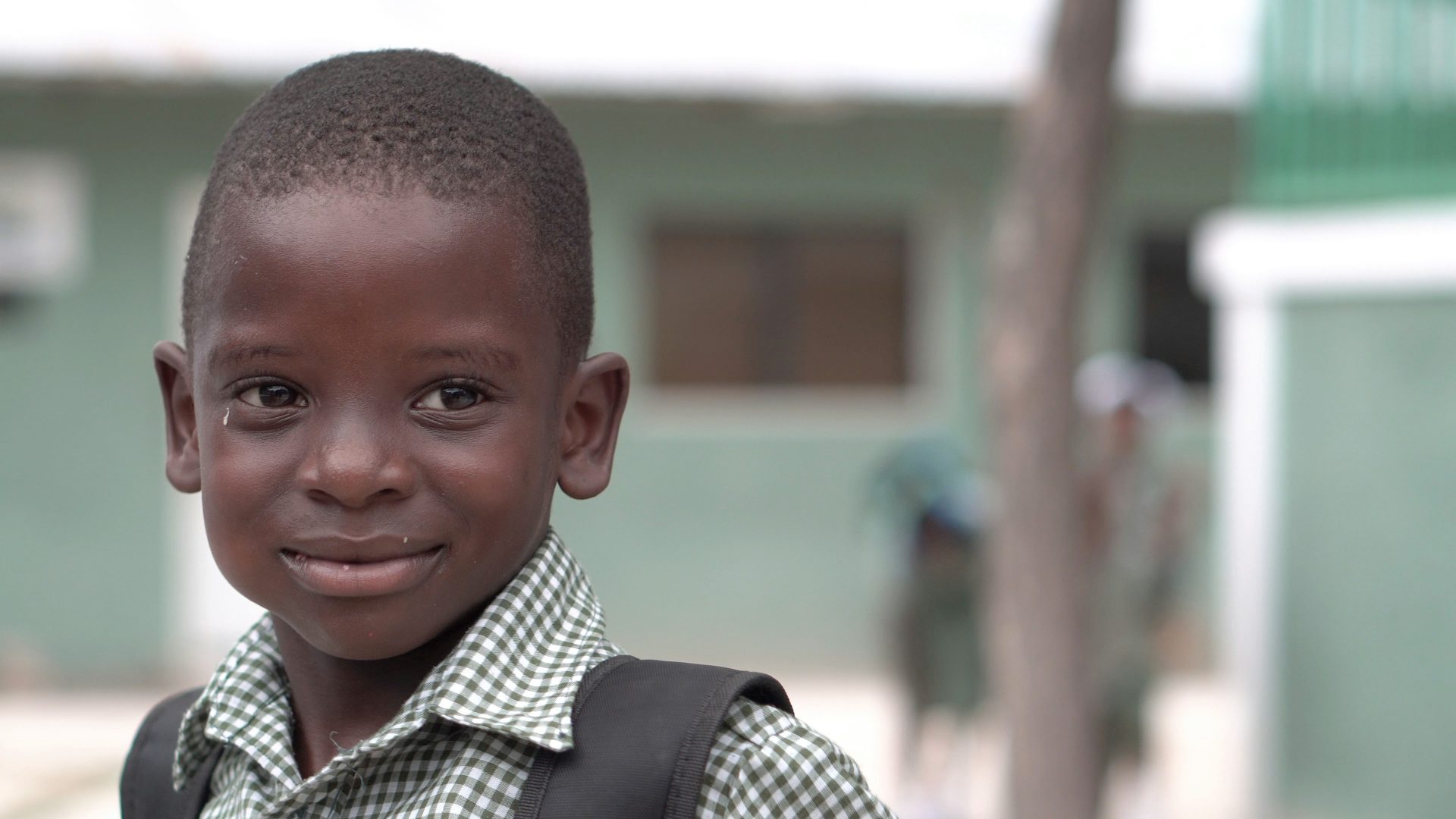 Smiling boy in checkered shirt